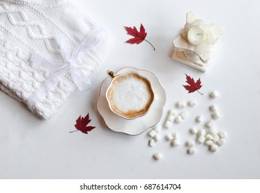 Autumn composition. Hot chocolate, knitted blanket, marshmallows, candlestick and autumn leaves. Flat lay, top view - Powered by Shutterstock