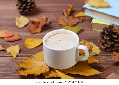 Autumn composition with leaves and a cup of coffee.
