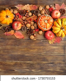 Autumn Composition. Pumpkins, Cones, Berries, Apples, Nuts, Cinnamon On Wooden Table Background. Symbol Of Fall Season. Harvest, Thanksgiving Concept. Flat Lay. Copy Space