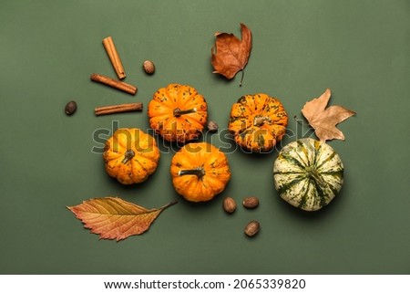 Autumn composition with pumpkins and spices on color background