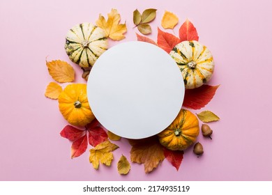 Autumn composition with round paper blank and dried leaves with pumpkin on table. Flat lay, top view, copy space. - Shutterstock ID 2174935119