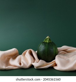 Autumn concept of zucchini  on a green background with saten fabric cloth. - Shutterstock ID 2045361560