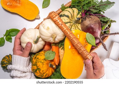 Autumn cooking, organic farm food background. Harvesting concept. Basket with fresh vegetables colorful pumpkins, squash, beetroot, carrots, cabbage, on a white marble table. cooking background - Powered by Shutterstock