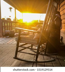 Autumn Country front porch with rocking chair at sunset with sun burst at golden hour