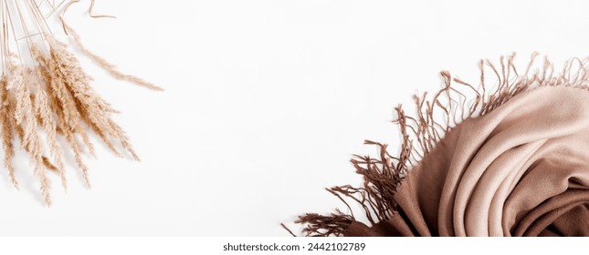 Autumn cozy composition. Beautiful scarf or shawl and dry plant flowers on  white background. Autumn relaxation concept. Flat lay, top view, copy space - Powered by Shutterstock