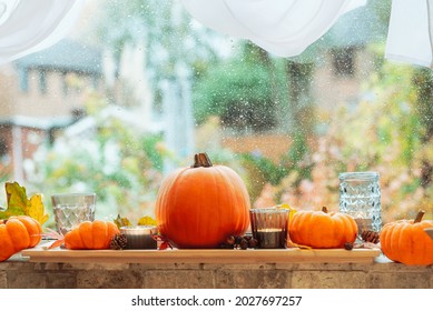 Autumn Cozy Mood Composition On The Windowsill. Pumpkins, Candles, Dried Leaves On The Wooden Tray Against A Rainy Window. Thanksgiving, Fall, Hygge Home, Natural Decor. Selective Focus. Copy Space