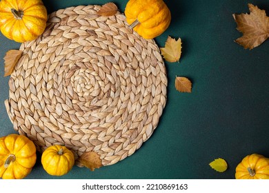 Autumn Cozy Table Setting Background. Top View Of Wicker Place Mat, Pumpkins, Autumn Leaves On Dark Table. Autumnal Hygge Table Setting. Restaurant Menu. Copy Space