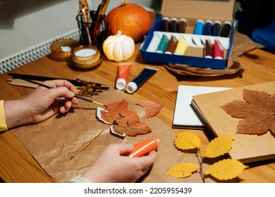 Autumn craft from dried leaves  DIY Fall Crafts for Adults  Fall nature collage  Female hands drawing fox face dry maple leaf