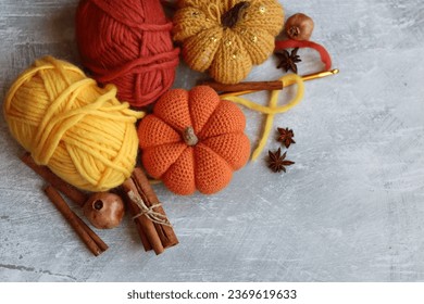 Autumn crochet. Close  up photo of handmade amigurumi toys made of natural yarn. Cute decorations for autumn holidays. Hobbies and leisure concept. 