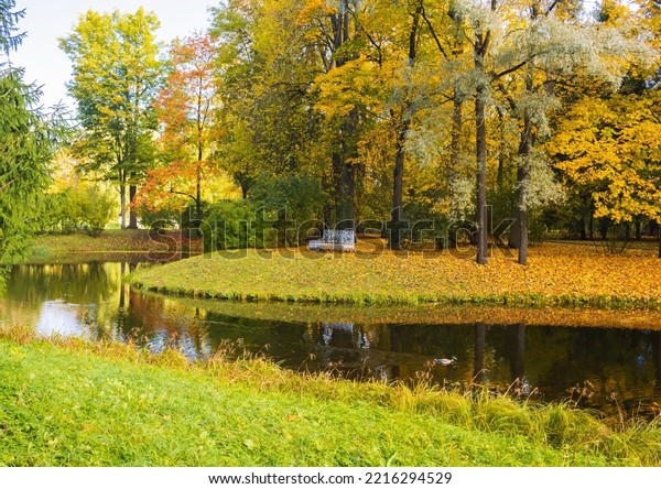 Autumn day\
in the park. Gold autumn. Trees and\
lake.