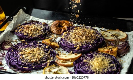 Autumn Dish Of Red Cabbage Baked With Nuts, Quince, And Apples. Flying Nuts Scattering In A Freeze Motion. Traditional German Cuisine.