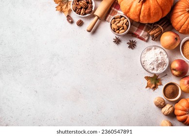 Autumn fall baking background with pumpkins, apples, nuts, food ingredients and seasonal spices on white, top view, copy space. Cooking pumpkin or apple pie for Thanksgiving and autumn holidays. - Powered by Shutterstock