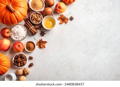 Autumn fall baking background with pumpkins, apples, nuts, food ingredients and seasonal spices on white, top view, copy space. Cooking pumpkin or apple pie for Thanksgiving and autumn holidays.