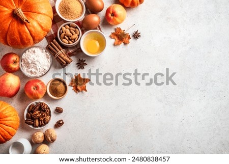 Autumn fall baking background with pumpkins, apples, nuts, food ingredients and seasonal spices on white, top view, copy space. Cooking pumpkin or apple pie for Thanksgiving and autumn holidays.