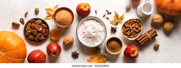 Autumn fall baking food background with pumpkins, apples, nuts and seasonal spices, banner. Cooking pumpkin or apple pie and cookies for Thanksgiving and autumn holidays. - Powered by Shutterstock