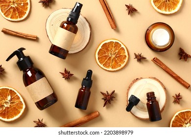 Autumn fall cosmetics. Amber glass bottles, dry orange slices, cinnamon sticks, anise stars on beige table. - Powered by Shutterstock