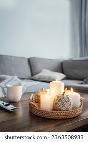 Autumn fall cozy mood composition for hygge home decor. Orange pumpkins, burning candles, cup with hot drink and remote controller on coffee table in living room. Movie night at home. Cozy relax time - Shutterstock ID 2363508933