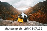 Autumn Fall Foliage Indian Head Adirondacks Hiking Adventure Couple Sit Together, Arms Raised On Top of Mountain at Sunset. Exciting Landscape