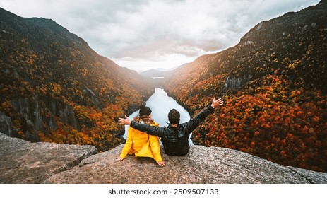 Autumn Fall Foliage Indian Head Adirondacks Hiking Adventure Couple Sit Together, Arms Raised On Top of Mountain at Sunset. Exciting Landscape - Powered by Shutterstock