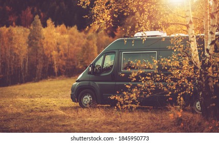 Autumn Fall Foliage RV Recreational Vehicle Camper Van Road Trip and Scenic Camping in Beautiful Place. Motorhome and the Scenic Nature. Travel Theme. - Powered by Shutterstock