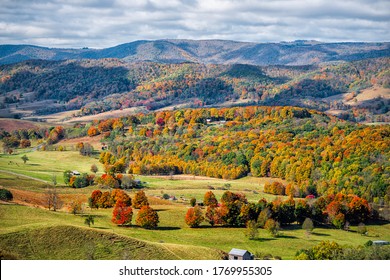 Autumn Fall Orange Red Colorful Trees Forest And Farm Houses Buildings On Rolling Hills Aerial Above High Angle View Landscape In Monterey And Blue Grass, Highland County, Virginia