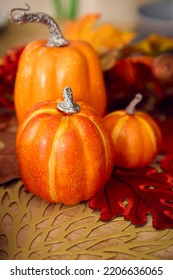 Autumn Or Fall Table Decoration At Home With Pumpkins And Leaves