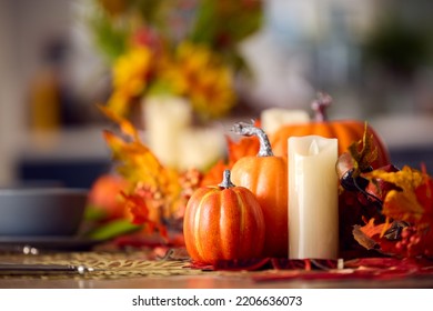 Autumn Or Fall Table Decoration At Home With Pumpkins Candle And Leaves