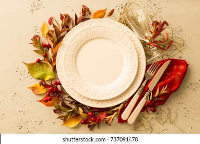 Autumn (fall) Or Thanksgiving Table Setting Design Captured From Above (top View, Flat Lay). Empty White Plate, Glass, Cutlery And Decorations (colorful Leaves). Background With Free Text Space.