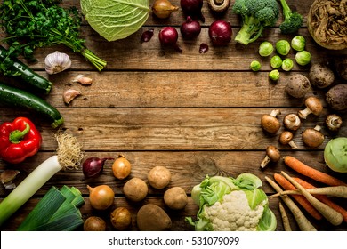Autumn (fall) vegetables on vintage rustic wooden background. Rural kitchen table - flat lay composition (from above, top view). Layout with free text space.