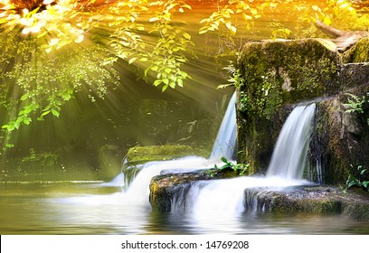Autumn Falls, light shafts burst through forest onto wide angle long exposure capture of Waterfalls