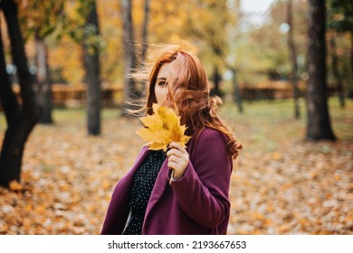 Autumn Fashion, Earth Tones Style, Bright Fall Color Palette. Portrait Of Red-haired Girl In Purple Coat