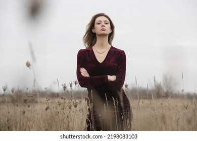 Autumn Fashion Outdoor Portrait Of Young Woman In Purple Red Plush Velvet Midi Dress. 