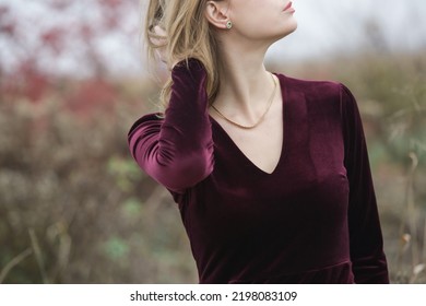 Autumn Fashion Outdoor Portrait Of Young Woman In Purple Red Plush Velvet Midi Dress. 