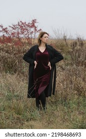 Autumn Fashion Outdoor Portrait Of Young Woman In Purple Red Plush Velvet Midi Dress. 