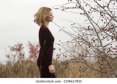 Autumn Fashion Outdoor Portrait Of Young Woman In Purple Red Plush Velvet Midi Dress. 