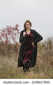 Autumn Fashion Outdoor Portrait Of Young Woman In Purple Red Plush Velvet Midi Dress. 