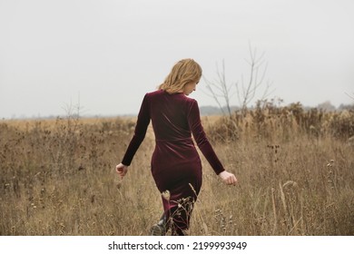 Autumn Fashion Outdoor Portrait Of Young Woman In Purple Red Plush Velvet Midi Dress.	