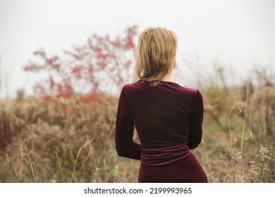 Autumn Fashion Outdoor Portrait Of Young Woman In Purple Red Plush Velvet Midi Dress.	