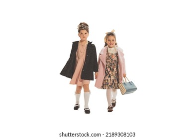 Autumn Fashion. Studio Shot Of Little Happy Girls In Retro Style Outfit Of 70s, 80s Fashion Style Isolated On White Background. Concept Of Emotions, Facial Expression, Beauty. Copy Space For Ad