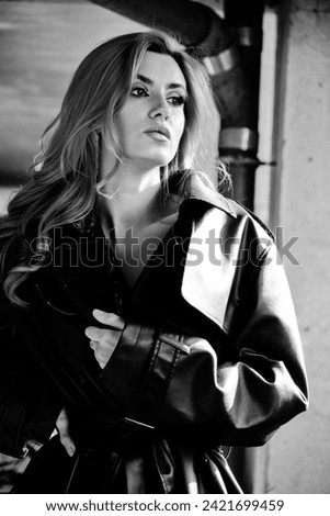 Autumn fashion trends. Red hair woman in black leather coat posing monochrome