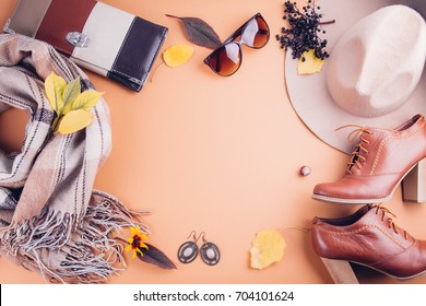 Autumn female outfit. Set of clothes, shoes and accessories on brown background - Powered by Shutterstock