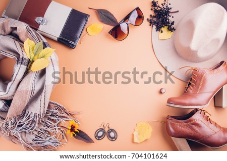 Autumn female outfit. Set of clothes, shoes and accessories on brown background