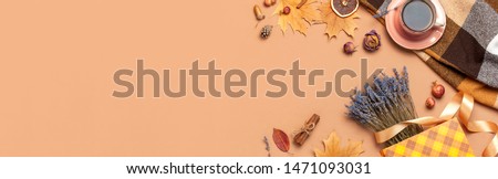Autumn Flat lay composition. Cup of tea, autumn dry leaves, roses flowers, lavender, gift bag cones decorative pomegranate cinnamon sticks on brown background top view. Autumn, fall concept. 