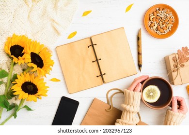 Autumn Flat Lay With Notebook, Tea With Female Hands, Phone, Nuts, Gift On Table