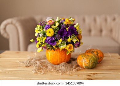 Autumn floral bouquet in a pumpkin vase for Halloween - Powered by Shutterstock