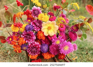 Autumn flowers close-up background texture. Beautiful fall pink yellow orange red purple bouquet with dahlia, aster, marigold flower and colorful leaves - Powered by Shutterstock