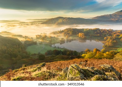 Autumn Fog Lingering Over Loughrigg Tarn In The English Lake District.