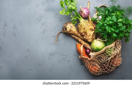 Autumn Food Background With Vegetables, Root Crops In String Bag: Celery, Radish, Parsnips, Carrots. Harvesting, Local Farm Market Shopping, Healthy Eating Concept. Top View