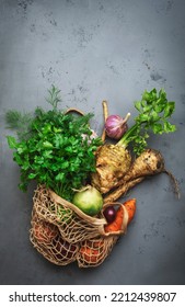 Autumn Food Background With Vegetables, Root Crops In String Bag: Celery, Radish, Parsnips, Carrots. Harvesting, Local Farm Market Shopping, Healthy Eating Concept. Top View