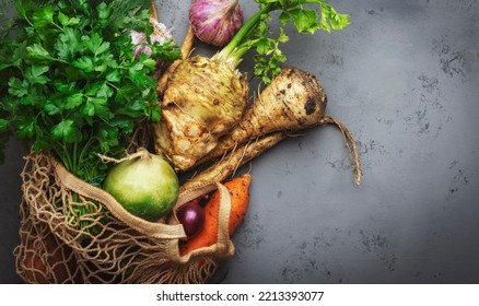 Autumn Food Background With Vegetables, Root Crops In String Bag: Celery, Radish, Parsnips, Carrots. Harvesting, Local Farm Market Shopping, Healthy Eating Concept. Top View